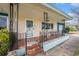 Quaint front porch with decorative railings and room to sit and enjoy the neighborhood at 908 Woodley Rd, Clearwater, FL 33764