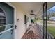 Relaxing covered porch with seating, decorative railings, and a charming welcome mat at 908 Woodley Rd, Clearwater, FL 33764