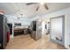 Bright kitchen featuring stainless steel appliances, black and white cabinets, and wood flooring at 908 Woodley Rd, Clearwater, FL 33764