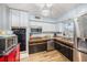 Well-lit kitchen showcasing stainless steel appliances, granite counters, and light wood flooring at 908 Woodley Rd, Clearwater, FL 33764