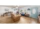 Bright living room with hardwood floors, ample seating, and a stylish blue front door at 908 Woodley Rd, Clearwater, FL 33764