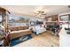 Inviting living room with brick fireplace, bunk beds, and natural light from large windows at 908 Woodley Rd, Clearwater, FL 33764