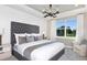 Well-lit primary bedroom with a decorative ceiling fan and neutral decor at 9821 Crescent Moon Dr, Riverview, FL 33578