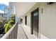 Exterior balcony showcasing neutral stucco walls, iron railings, and a view of lush greenery at 105 4Th Ne Ave # 405, St Petersburg, FL 33701