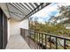 Balcony with striped awning, iron railing, and views of surrounding trees and buildings at 105 4Th Ne Ave # 405, St Petersburg, FL 33701