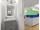 Modern bathroom with updated vanity and fixtures, with a view into the kitchen area at 105 4Th Ne Ave # 405, St Petersburg, FL 33701