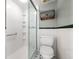 Shower with white tiling and storage basket by the toilet at 105 4Th Ne Ave # 405, St Petersburg, FL 33701