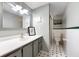 Cozy bathroom with white tiling, gray vanity, and modern fixtures at 105 4Th Ne Ave # 405, St Petersburg, FL 33701