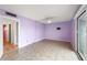 Large bedroom with light purple walls, tile floors, a ceiling fan, and sliding glass doors at 105 4Th Ne Ave # 405, St Petersburg, FL 33701