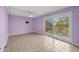 Bright, tiled bedroom featuring a ceiling fan, sliding glass doors, and a walk-in closet at 105 4Th Ne Ave # 405, St Petersburg, FL 33701