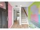 Light-filled condo entryway features wood floors, colorful walls, and stairs to the upper level at 105 4Th Ne Ave # 405, St Petersburg, FL 33701