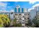 Exterior shot of condo building featuring balconies and lush landscaping at 105 4Th Ne Ave # 405, St Petersburg, FL 33701