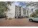 Exterior shot of condo building featuring a red brick parking area and well-maintained landscaping at 105 4Th Ne Ave # 405, St Petersburg, FL 33701