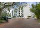Apartment building featuring multiple stories and balconies, surrounded by lush trees at 105 4Th Ne Ave # 405, St Petersburg, FL 33701