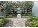 Outdoor community grill surrounded by mature landscaping and tiled patio at 105 4Th Ne Ave # 405, St Petersburg, FL 33701