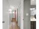 Hallway with wood floors leads to vanity and sink area at 105 4Th Ne Ave # 405, St Petersburg, FL 33701