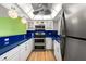 Well-equipped kitchen featuring stainless steel appliances, white cabinetry, blue countertops, and unique lighting at 105 4Th Ne Ave # 405, St Petersburg, FL 33701