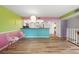 Bright living room with wood floors, vibrant accent walls, and an open layout to the kitchen with stainless appliances at 105 4Th Ne Ave # 405, St Petersburg, FL 33701