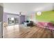 Open living room with hardwood floors, sofa, and balcony access at 105 4Th Ne Ave # 405, St Petersburg, FL 33701