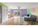 Open living room with hardwood floors, sofa, and balcony access at 105 4Th Ne Ave # 405, St Petersburg, FL 33701
