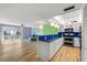 Open concept living and kitchen area with hardwood floors, with view of the balcony at 105 4Th Ne Ave # 405, St Petersburg, FL 33701