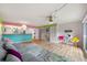 Bright living room with wood floors, vibrant accent walls, modern lighting, and a comfortable gray sectional sofa at 105 4Th Ne Ave # 405, St Petersburg, FL 33701