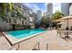 Beautiful outdoor community pool surrounded by landscaping, building balconies and lounge chairs at 105 4Th Ne Ave # 405, St Petersburg, FL 33701