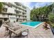 Outdoor community pool with lounge chairs, tables and well maintained landscaping at 105 4Th Ne Ave # 405, St Petersburg, FL 33701