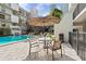 Outdoor community pool area with table, umbrella and chairs for residents to enjoy at 105 4Th Ne Ave # 405, St Petersburg, FL 33701