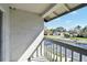 Balcony view of a street, mature trees, and residential homes, capturing a serene outdoor scene at 11201 122Nd Ave # 132, Largo, FL 33778