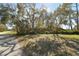 A stone sign marks the entrance to Walsingham Park, surrounded by mature trees and lush greenery at 11201 122Nd Ave # 132, Largo, FL 33778