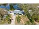 Aerial view of the property showing the house, driveway, and lush greenery, and water access at 1131 60Th Ave S, St Petersburg, FL 33705