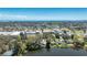 Wide aerial view of a home with a private lake in a lush surrounding landscape at 1131 60Th Ave S, St Petersburg, FL 33705