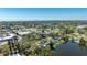 Wide aerial view of a neighborhood home with a private lake at 1131 60Th Ave S, St Petersburg, FL 33705