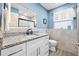 Bathroom featuring modern vanity with granite countertops, stylish tilework, and updated lighting at 1131 60Th Ave S, St Petersburg, FL 33705