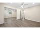 Bright bedroom features luxury vinyl floors and mirrored closet with a ceiling fan at 1131 60Th Ave S, St Petersburg, FL 33705