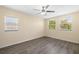 Bedroom features neutral walls, laminate flooring, natural light from two large windows, and ceiling fan at 1131 60Th Ave S, St Petersburg, FL 33705
