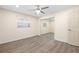 Bedroom featuring luxury vinyl floors and mirrored closet with a ceiling fan at 1131 60Th Ave S, St Petersburg, FL 33705