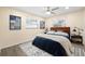 Bright bedroom features a ceiling fan, black and white rug, and natural light from the two windows at 1131 60Th Ave S, St Petersburg, FL 33705