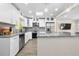 Modern kitchen featuring granite countertops, white cabinetry, stainless appliances, and ample counter space at 1131 60Th Ave S, St Petersburg, FL 33705