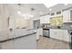 Beautiful kitchen featuring granite countertops, modern appliances, white cabinets, and an adjacent dining area at 1131 60Th Ave S, St Petersburg, FL 33705