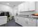 Well-equipped laundry room with modern cabinetry, a granite countertop, and a sleek design at 1131 60Th Ave S, St Petersburg, FL 33705