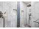 Walk-in shower with marble tiling and built-in shelving at 1131 60Th Ave S, St Petersburg, FL 33705