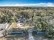Expansive property with a private gated entrance and a charming single-story residence surrounded by lush trees at 11335 Mcmullen Loop, Riverview, FL 33569