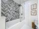 Bathroom showing tiled shower with rainfall shower head, mosaic accent wall, and hexagon tile flooring at 11335 Mcmullen Loop, Riverview, FL 33569