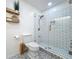 Bright bathroom with tiled shower, decorative shelving, and patterned tile flooring at 11335 Mcmullen Loop, Riverview, FL 33569