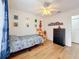 Spacious bedroom with wood floors, ceiling fan, and colorful decor at 11335 Mcmullen Loop, Riverview, FL 33569