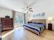Bedroom featuring a ceiling fan, light-colored walls, and a blue and white bedspread at 11335 Mcmullen Loop, Riverview, FL 33569