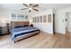 Bedroom featuring a ceiling fan, light-colored walls, and a blue and white bedspread at 11335 Mcmullen Loop, Riverview, FL 33569