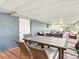 Covered back patio area with comfortable seating and a wooden floor at 11335 Mcmullen Loop, Riverview, FL 33569